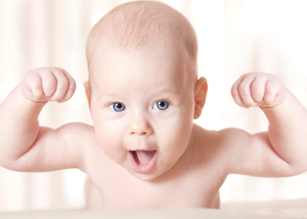 A baby with arms up in a flex pose